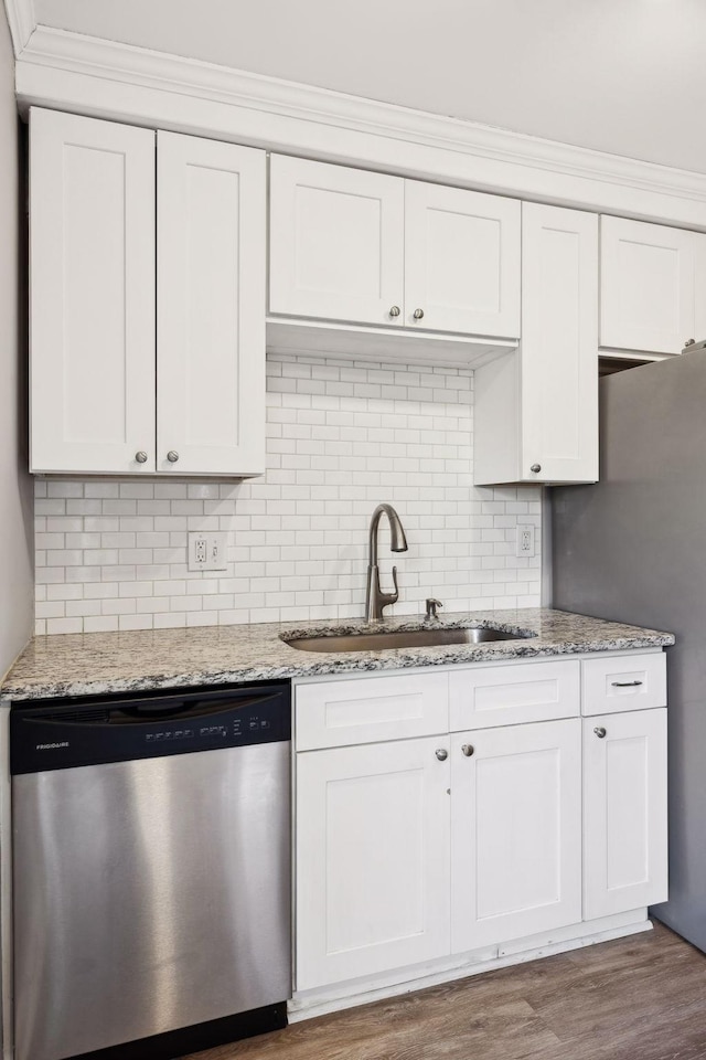 kitchen featuring white cabinetry, sink, light stone countertops, and appliances with stainless steel finishes