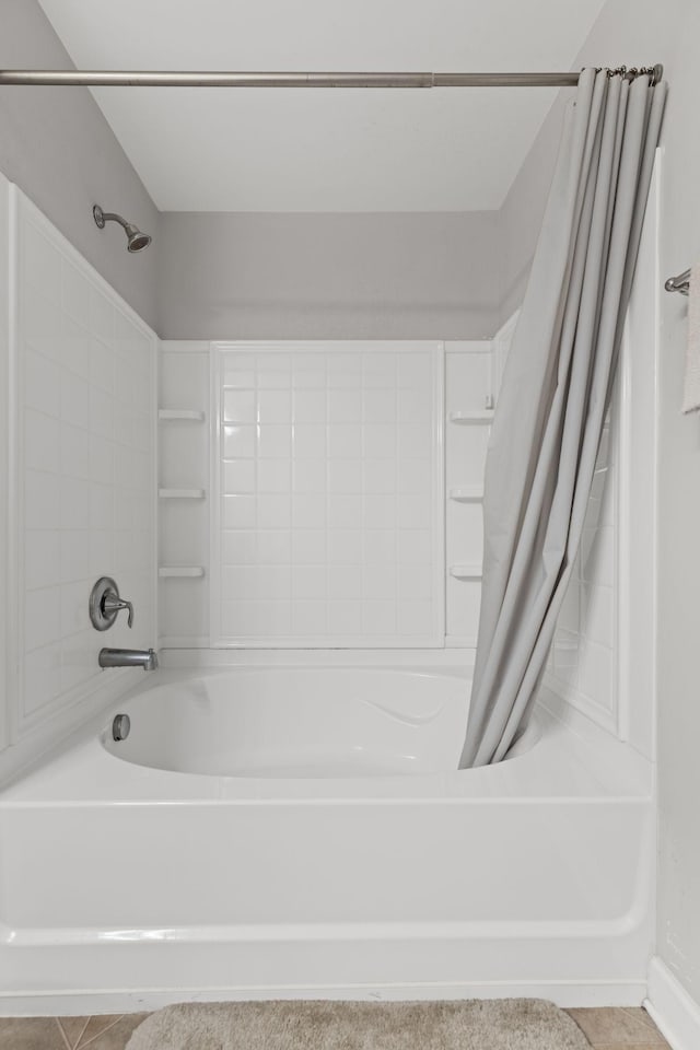 bathroom with shower / tub combo with curtain