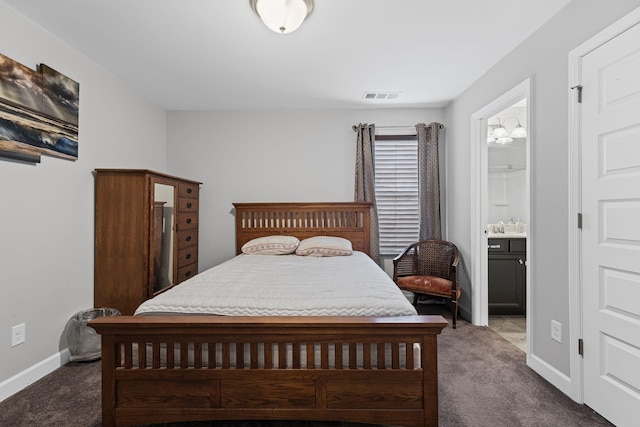 carpeted bedroom featuring ensuite bath