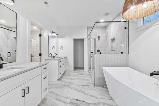 bathroom featuring vanity and separate shower and tub