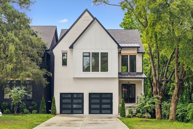 modern farmhouse featuring a garage and a front yard