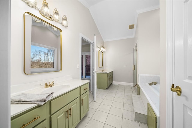 bathroom featuring tile patterned flooring, crown molding, tiled bath, and vanity