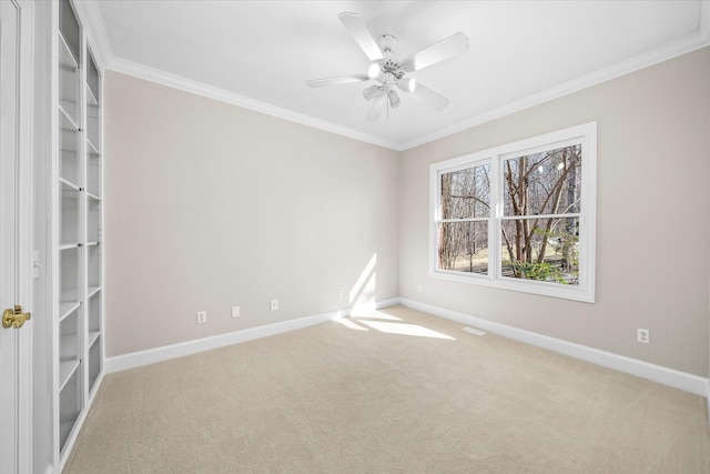 carpeted empty room featuring ceiling fan and ornamental molding