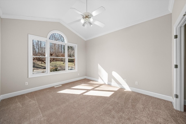 carpeted spare room with vaulted ceiling, ornamental molding, and ceiling fan