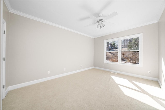 spare room featuring crown molding, light colored carpet, and ceiling fan