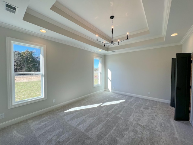 unfurnished room with a tray ceiling, visible vents, light carpet, and baseboards