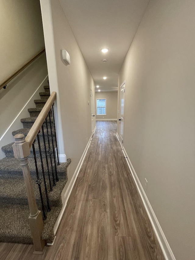 hallway with hardwood / wood-style flooring