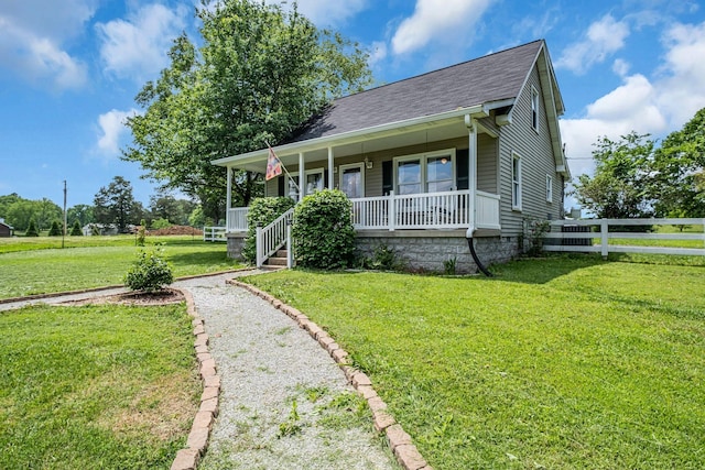 view of front of property featuring covered porch and a front yard