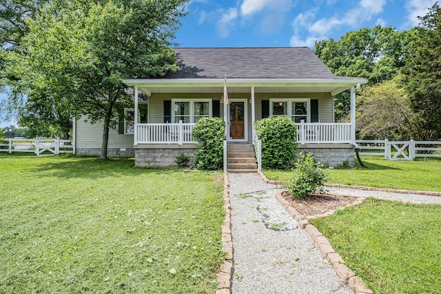 bungalow-style home with a front yard and covered porch