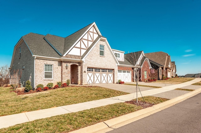 view of front of property with a garage and a front lawn