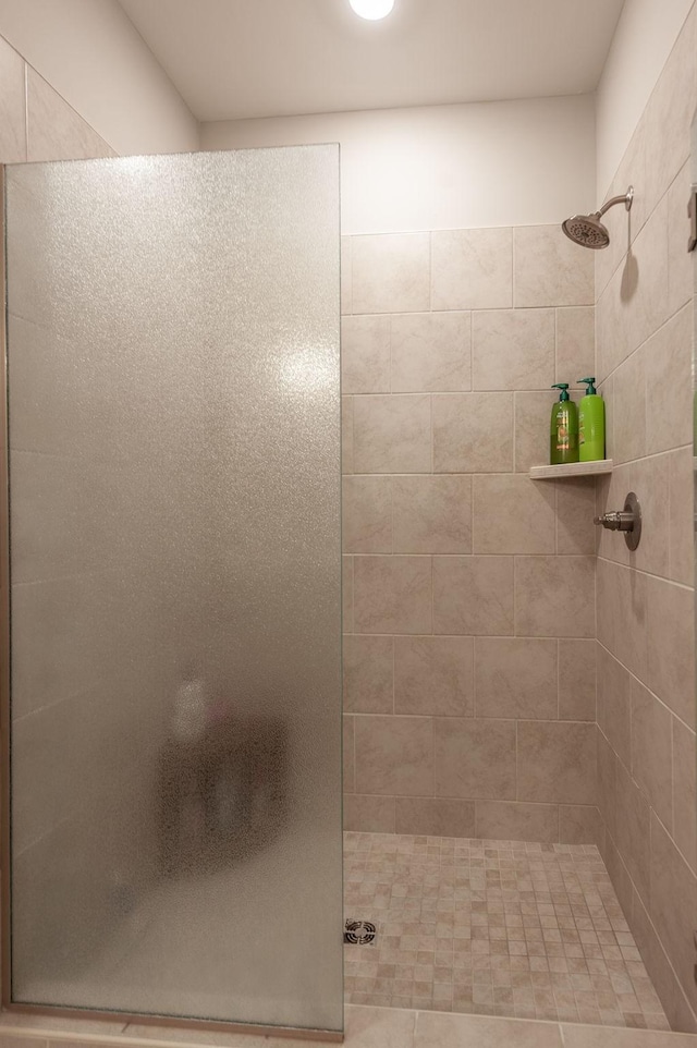 bathroom featuring a shower with door