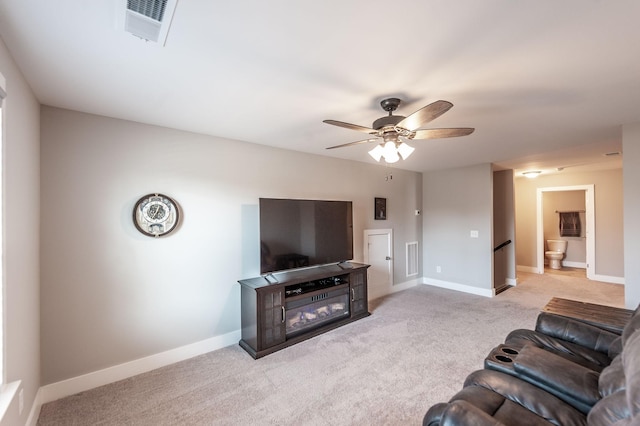 carpeted living room with ceiling fan