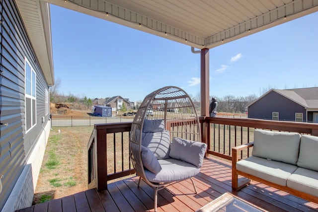 wooden deck featuring fence and an outdoor living space