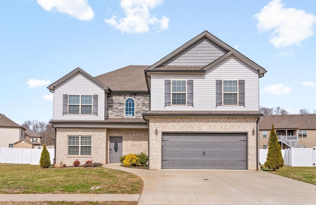 view of front of home with a garage, concrete driveway, fence, a front lawn, and brick siding