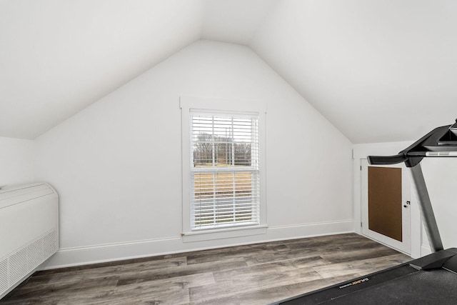 bonus room with hardwood / wood-style flooring and vaulted ceiling