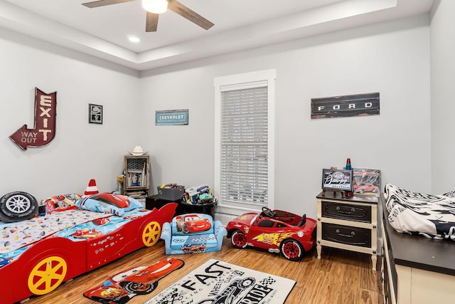 bedroom with ceiling fan and hardwood / wood-style floors