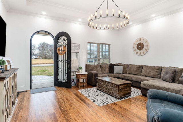 living room with ornamental molding and wood-type flooring