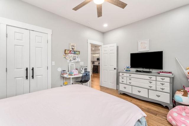 bedroom featuring a closet, ceiling fan, and light wood-type flooring