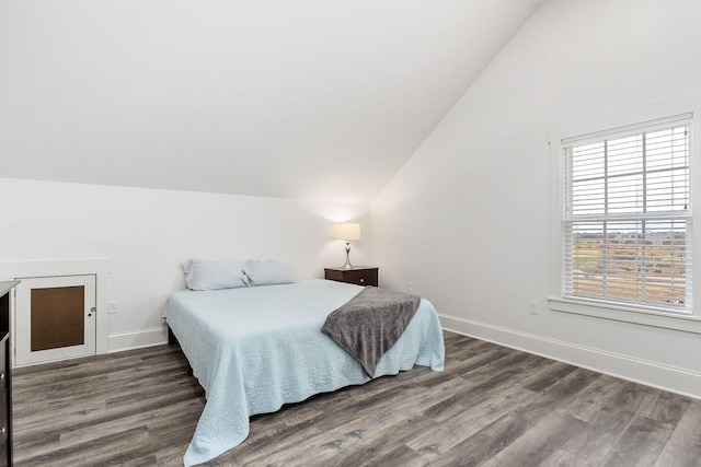 bedroom with lofted ceiling and dark hardwood / wood-style floors