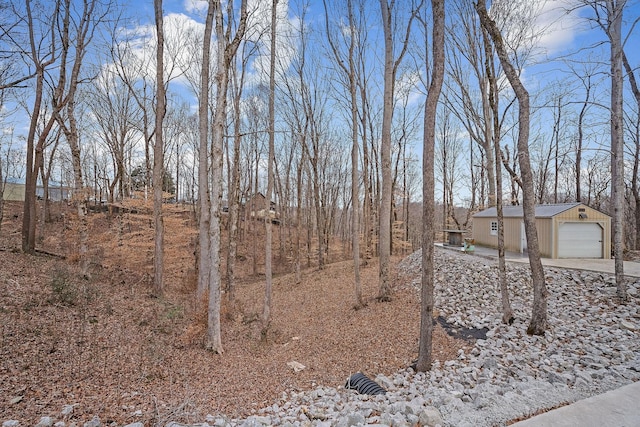 view of yard featuring an outbuilding and a garage