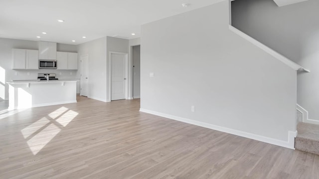 unfurnished living room featuring light hardwood / wood-style flooring