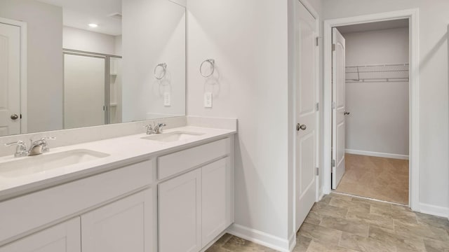 bathroom with vanity and a shower with shower door