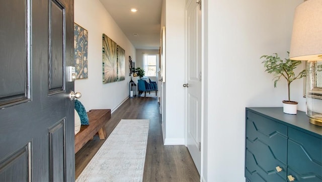 hallway featuring dark hardwood / wood-style flooring