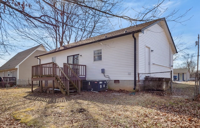 back of property with cooling unit and a deck