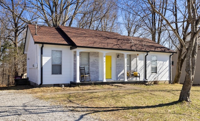 view of front of home with a front yard and a porch