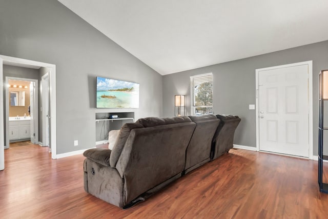 living room with high vaulted ceiling, wood-type flooring, and sink