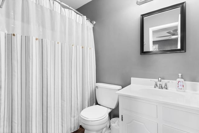 bathroom featuring vanity, toilet, and walk in shower