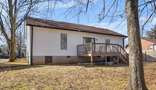 rear view of house featuring central AC unit, a deck, and a lawn