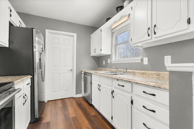 kitchen with white cabinetry, sink, and stainless steel dishwasher