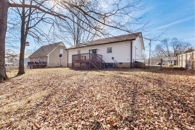 rear view of house featuring a wooden deck