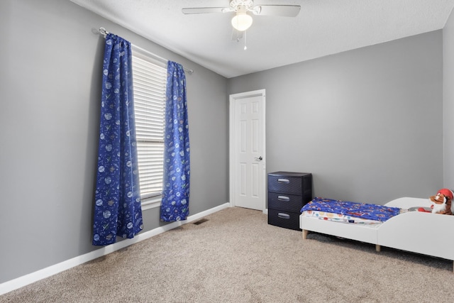 unfurnished bedroom with ceiling fan, carpet flooring, and a textured ceiling