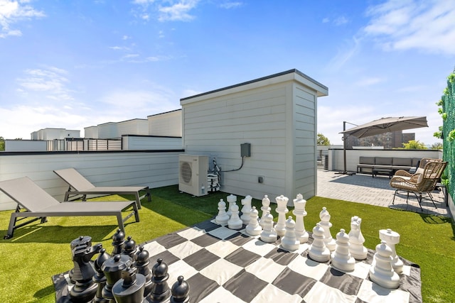 rear view of property with ac unit, a lawn, outdoor lounge area, and a patio