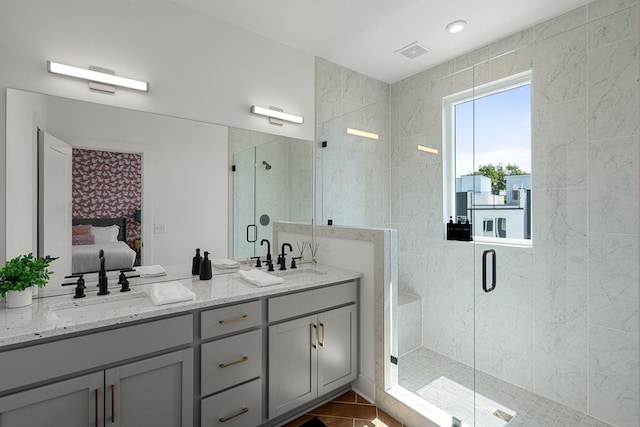 bathroom featuring tile patterned floors, vanity, and a shower with door