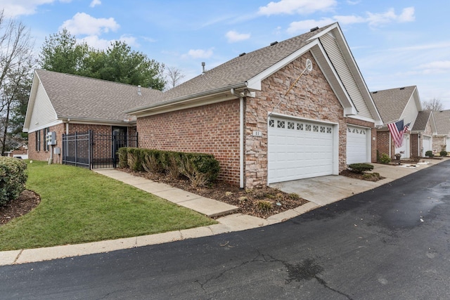 view of front of home with a garage and a front lawn