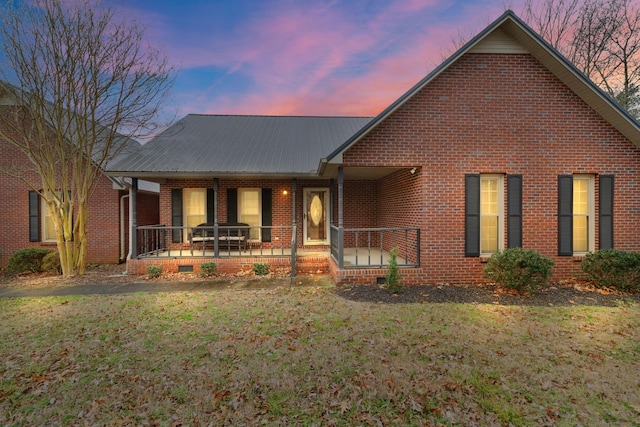 view of front of property with a yard and a porch