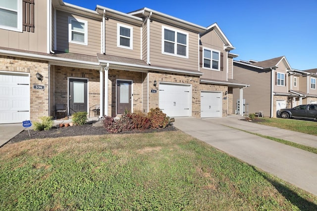 view of property with a garage and a front lawn