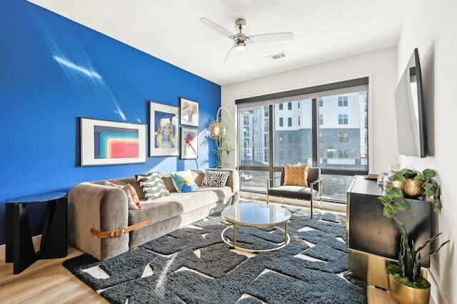 living room featuring hardwood / wood-style flooring and ceiling fan