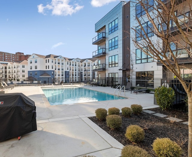 view of swimming pool featuring grilling area and a patio area