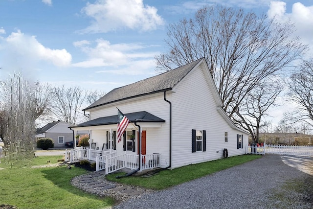 exterior space with covered porch and a lawn