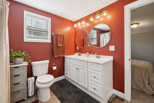 bathroom featuring vanity, tile patterned floors, and toilet