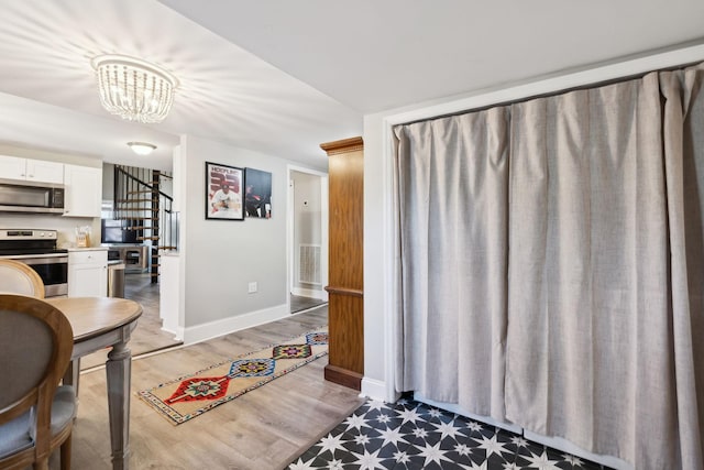 interior space with dark hardwood / wood-style floors and a notable chandelier