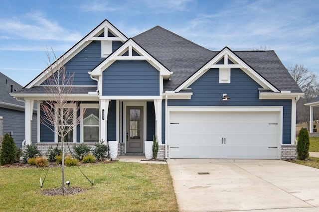 craftsman-style house featuring a garage and a front yard