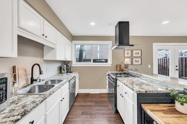 kitchen with sink, appliances with stainless steel finishes, white cabinetry, light stone counters, and island range hood