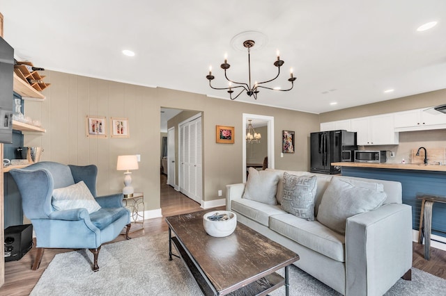 living room featuring light hardwood / wood-style flooring and a chandelier