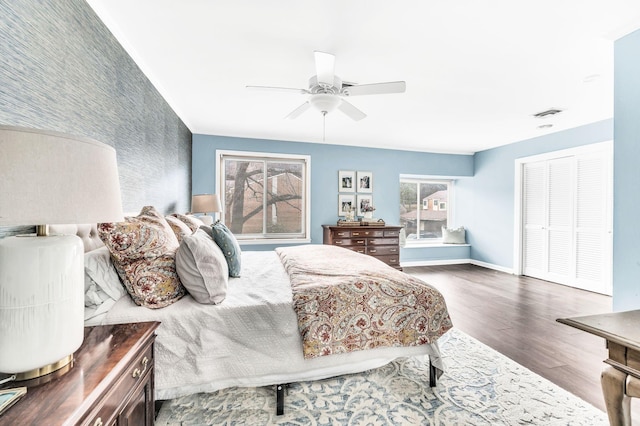 bedroom with ceiling fan, wood-type flooring, and a closet