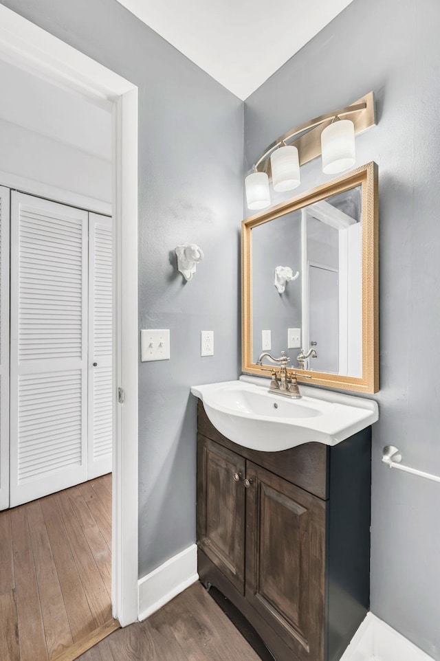 bathroom with hardwood / wood-style flooring and vanity